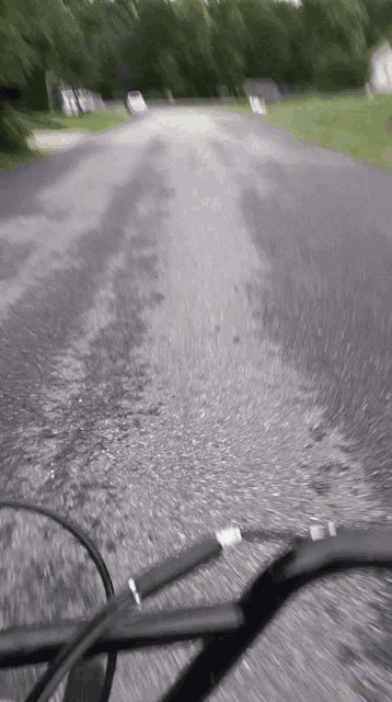 a blurry picture of a person riding a bike down a street