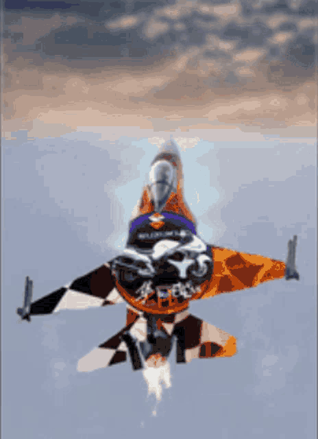 a fighter jet with a motorcycle on the side is flying in the sky