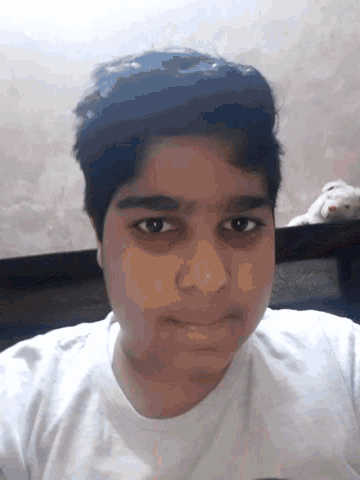 a young man with a nose ring looks at the camera