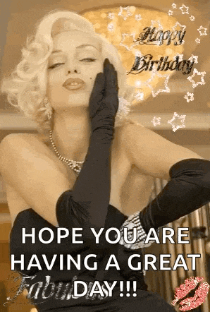 a woman in a black dress and black gloves is blowing a kiss and wishing someone a happy birthday .