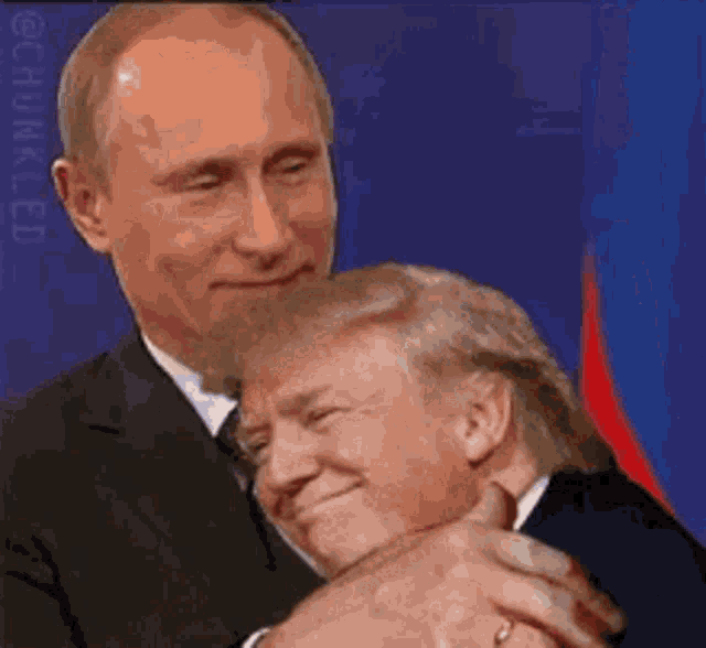 a man in a suit and tie is hugging a man in a suit and tie .