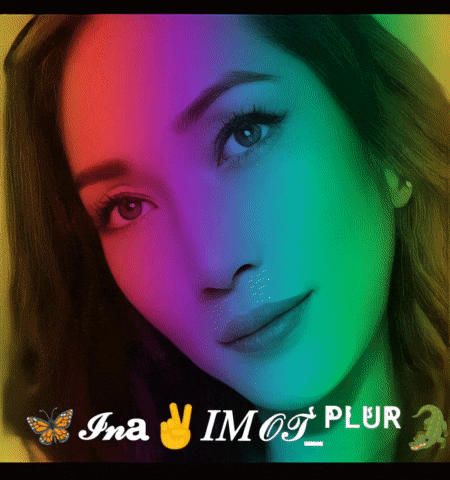 a woman 's face is surrounded by a rainbow colored background and the name ina is on the bottom right