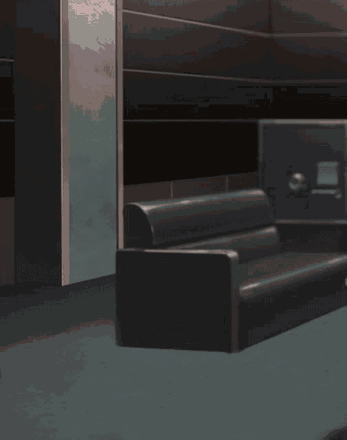 a man in a suit and glasses stands in a room with a couch