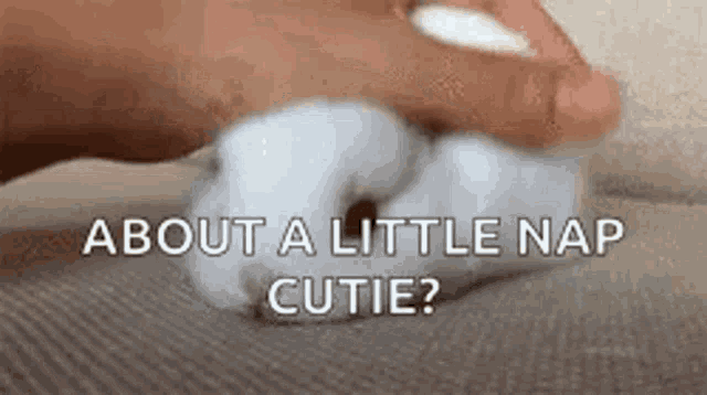 a person is holding a cotton ball in their hand .