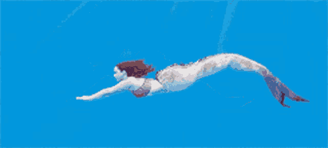 a mermaid is swimming in a blue water