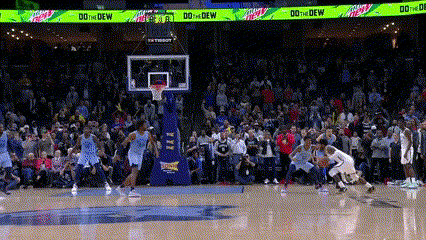 a basketball game is being played in front of a crowd with ads for mtn dew and tissot