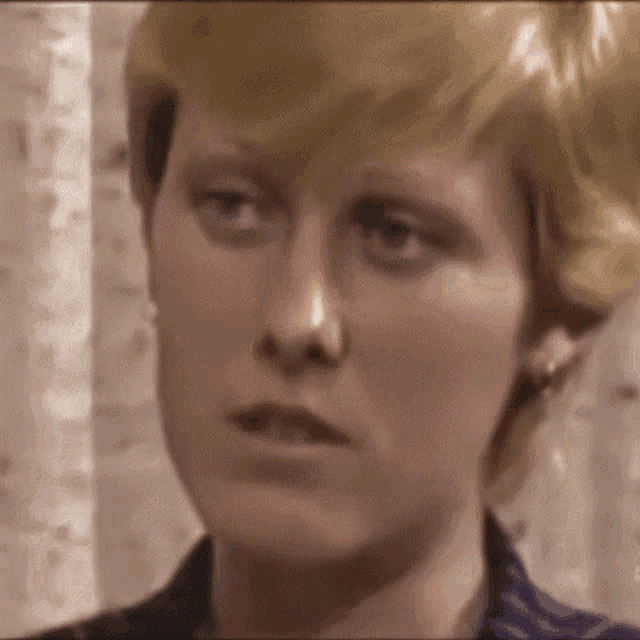 a close up of a woman 's face with blonde hair