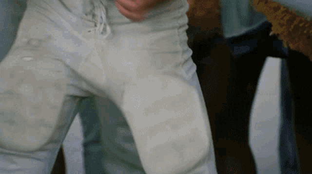 a close up of a person 's dirty pants with a few spots on them