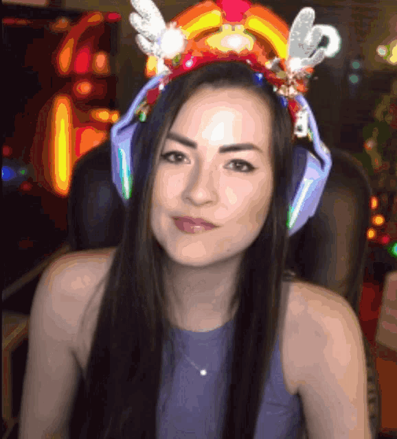 a woman wearing headphones and a headband with a rainbow on it