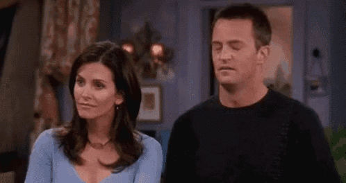 a man and a woman are sitting next to each other in a living room .