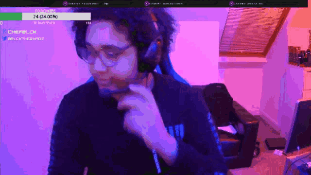 a man wearing headphones and glasses is playing a game