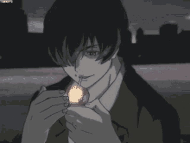 a man in a suit is lighting a cigarette with a lit match