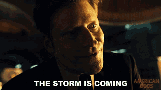 a close up of a man with the words the storm is coming behind him