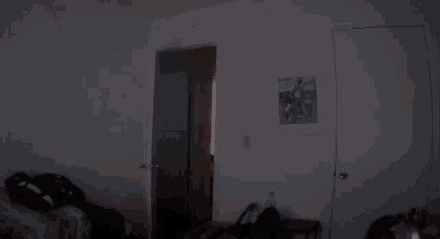a man without a shirt is dancing in a dark room