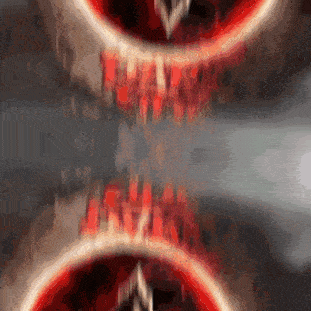 a blurry image of a red circle with a triangle in the middle of it