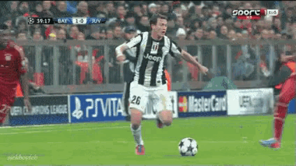a soccer player wearing a jeep jersey is running with a ball