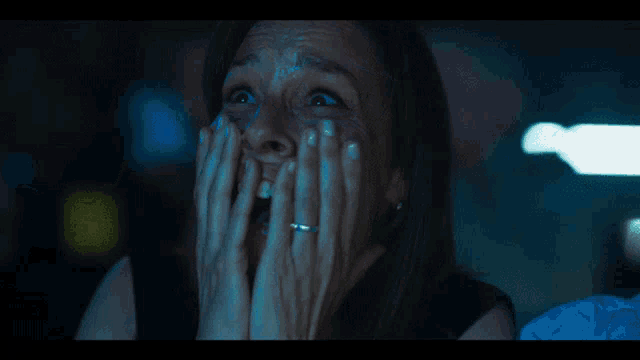 a woman with a ring on her finger is covering her face