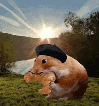 a hamster wearing a black hat is holding a croissant