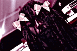a close up of a person 's hair with pink bows on it