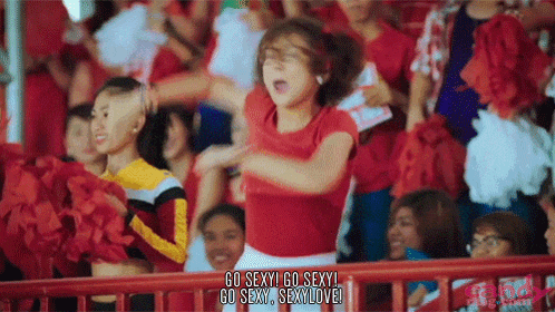 a group of cheerleaders are cheering in a stadium and one of them is saying go sexy go sexy go sexy