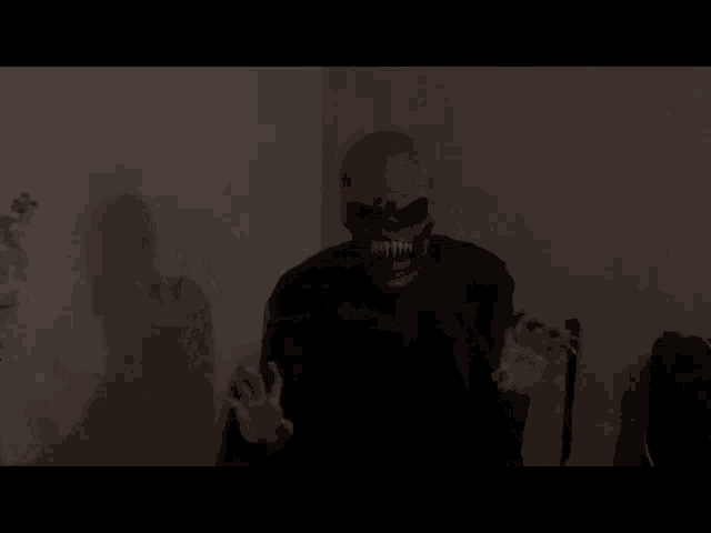 a skeleton with red lights on his eyes is standing in the dark .