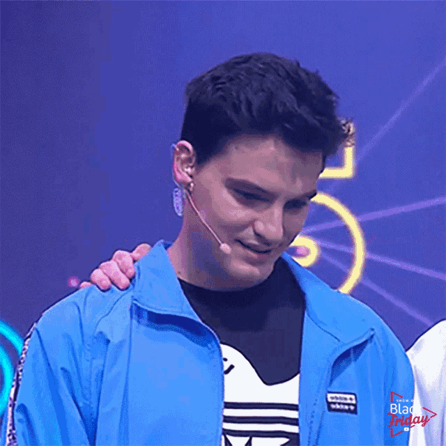 a man wearing a blue jacket and a black friday shirt