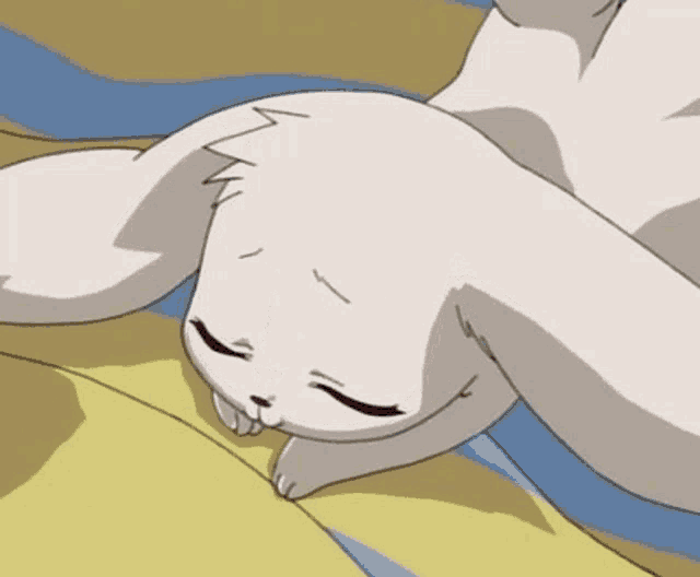 a white rabbit with red eyes is laying on its back on a bed .