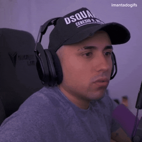 a man wearing headphones and a hat with the word dsquared on it