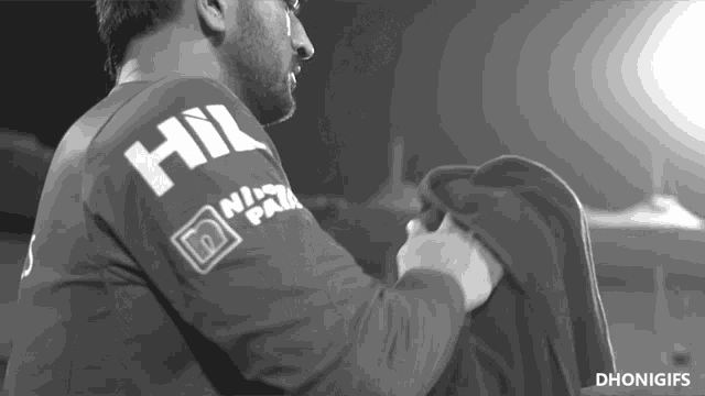a man is wearing a shirt that says hill on the back