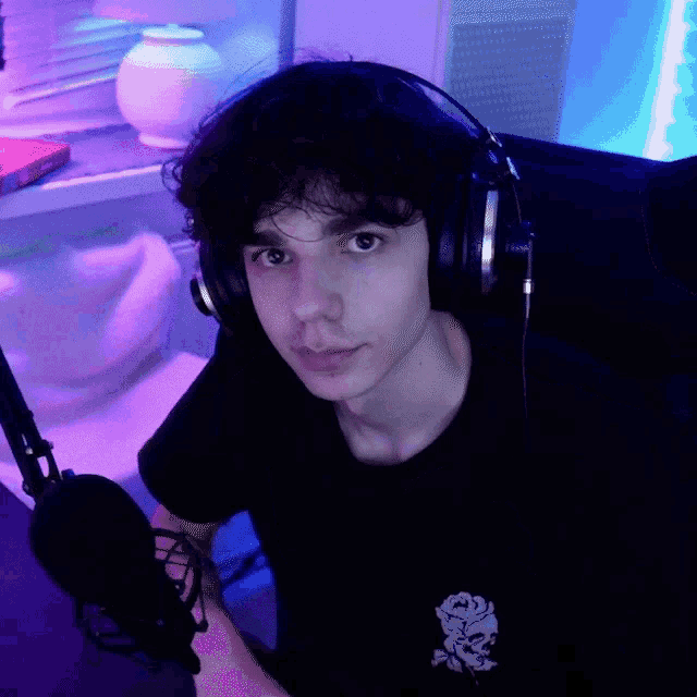 a young man wearing headphones and a black shirt