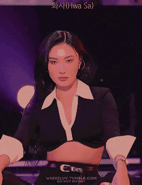 a woman in a black and white crop top with the words hwa sa written on the bottom