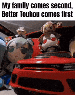 a group of stuffed animals are sitting in a red car .