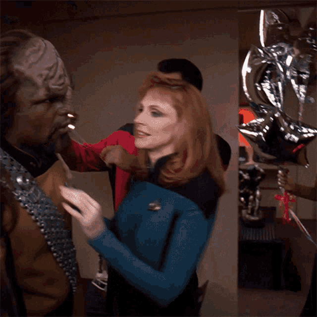 Putting A Party Hat Worf GIF - Putting A Party Hat Worf Deanna Troi GIFs