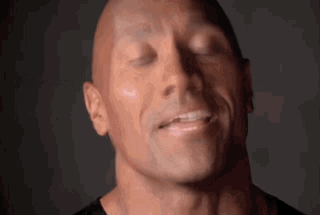 a close up of a man 's face with the words hey behind it