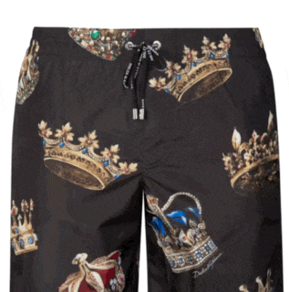 a pair of black swim trunks with a crown print