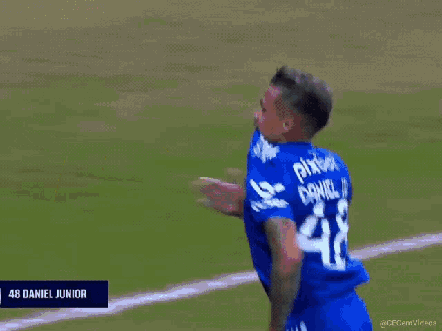 a soccer player wearing a blue shirt with the number 48 on it