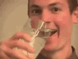 a close up of a man 's face with his mouth open smiling .
