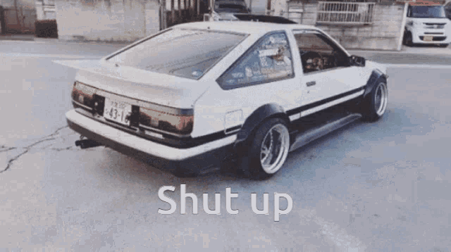 a white car with a license plate that says 43-16
