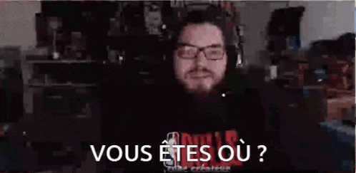a man with glasses and a beard is asking if he is a vous etes ou ?