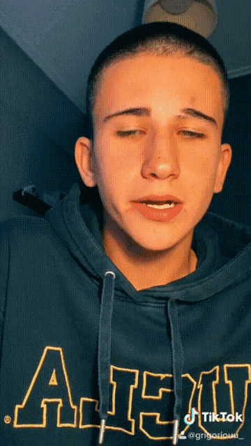 a young man is wearing a hoodie that says army