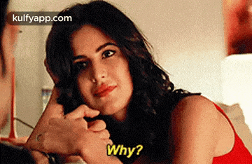 a woman in a red tank top is asking a man why .