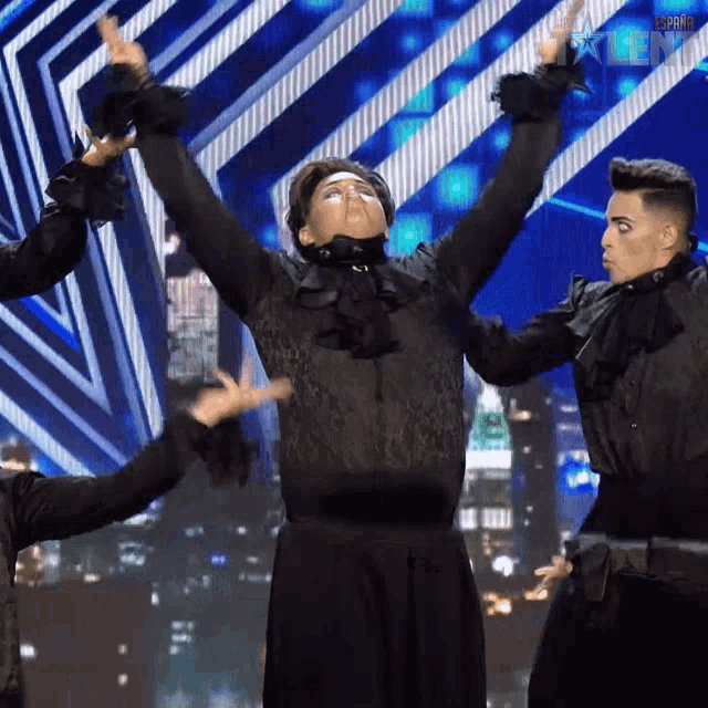 a group of dancers are performing on a stage with a sign that says ' spain ' on it