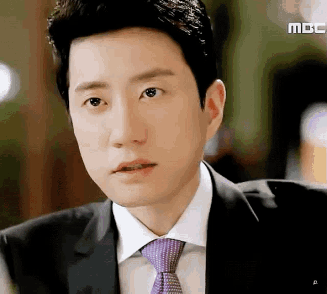 a close up of a man 's face with the word mbc on the bottom right