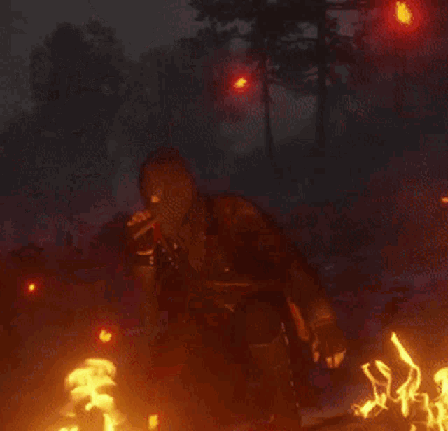 a man in a gas mask stands in front of a fire