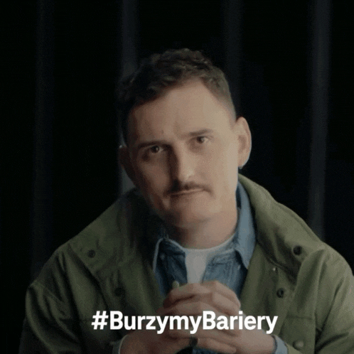 a man with a mustache is wearing a green jacket with the hashtag #burzymy bariery