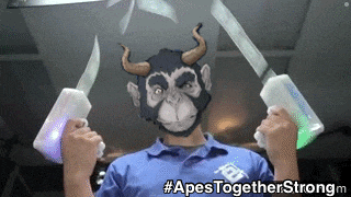 a man wearing a monkey mask is holding a pair of knives in his hands .