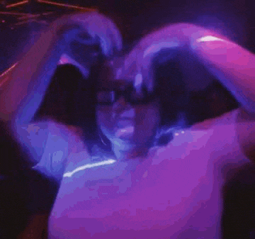 a woman wearing a pair of 3d glasses is dancing in a club .