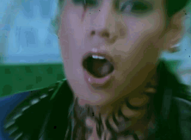a close up of a person 's face with their mouth open