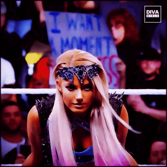 a woman in a wrestling ring with a sign that says i want a moment