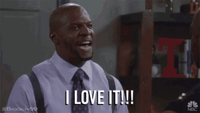 a man in a suit and tie is saying `` i love it '' .
